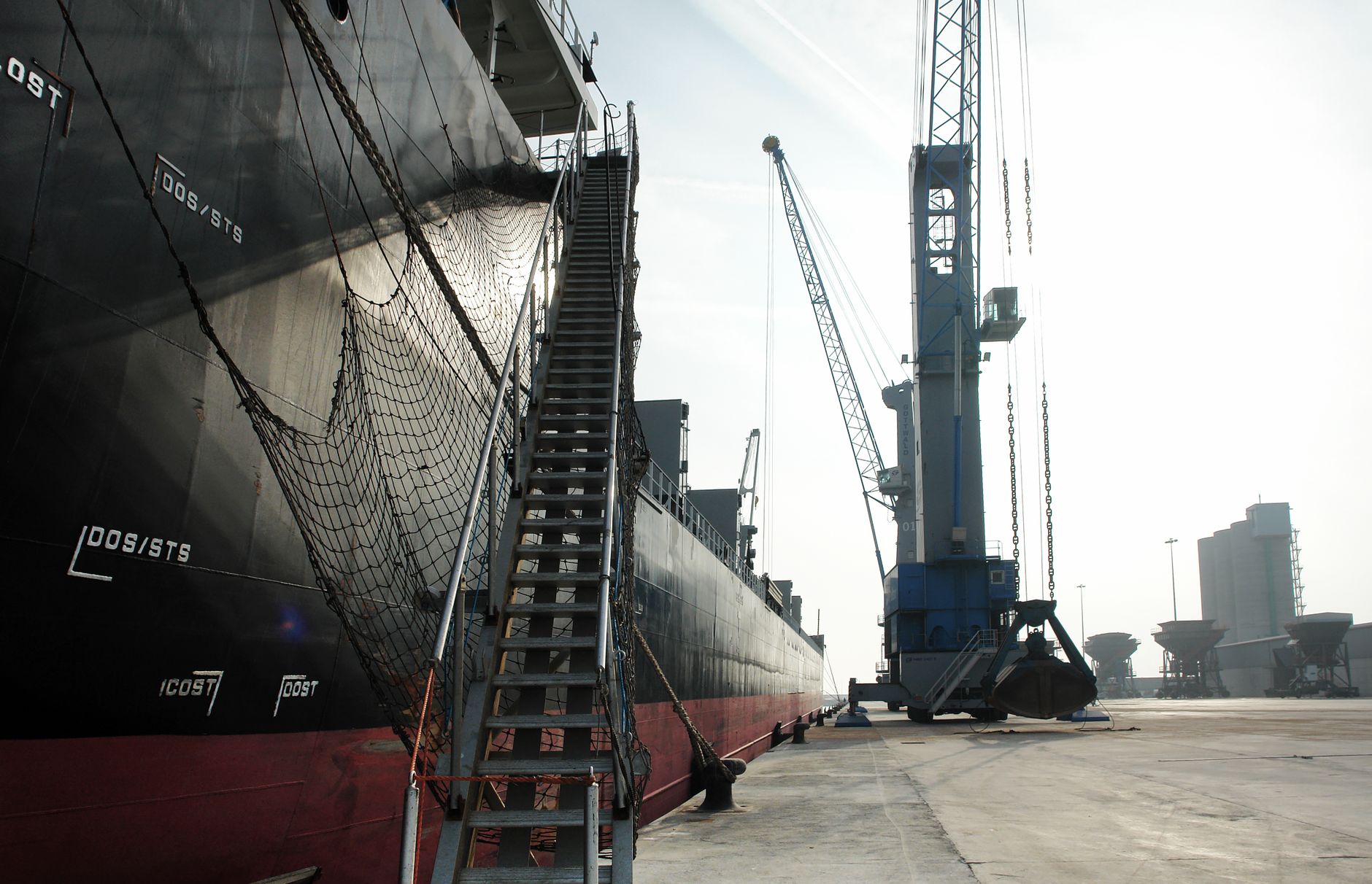 Cargo vessel alongside an industrial quay